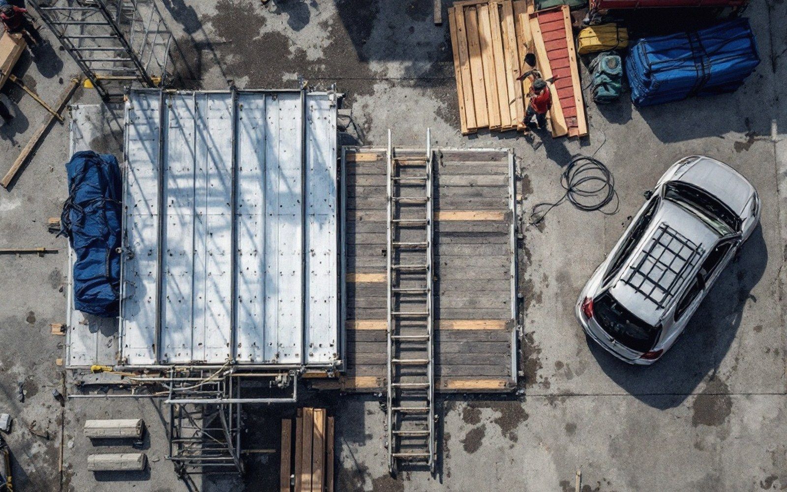 An aluminium ramp bolted to a timber deck on a wet concrete apron